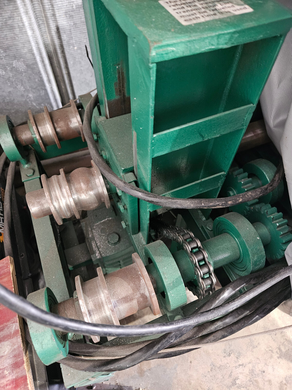 Texas Made Shade in-house metal bending machine with pulley and chain drive used to custom-bend aluminum and steel awning frames