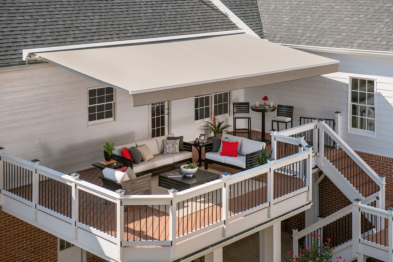 Solair® shaded patio styled with red pillows