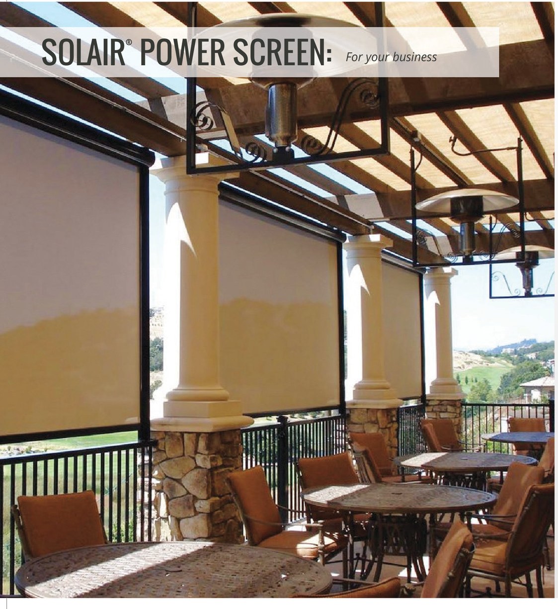 Solair® Power Screens lowered between stone columns along a commercial hillside patio, shading dining tables while keeping the valley view