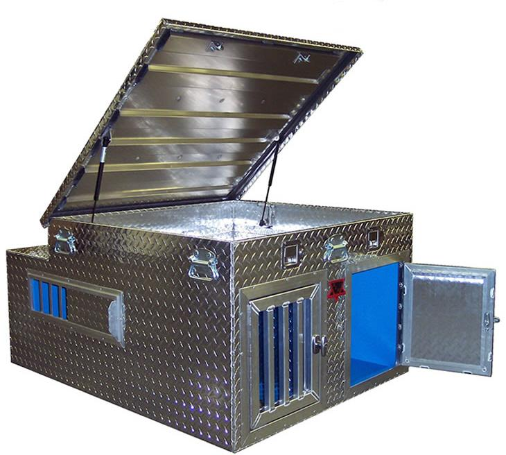 Custom welded diamond plate aluminum dog box with gas-strut top storage lid open, twin vented kennel doors, side vents and blue interior — built by Texas Made Shade in Seguin, TX