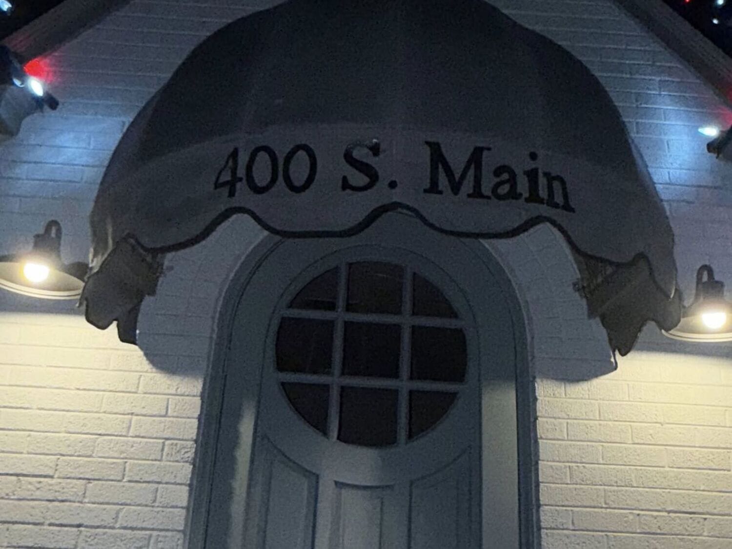 Custom welded aluminum entry awning with bold red Sunbrella canvas installed by Texas Made Shade at 400 S. Main Street in Seguin, Texas