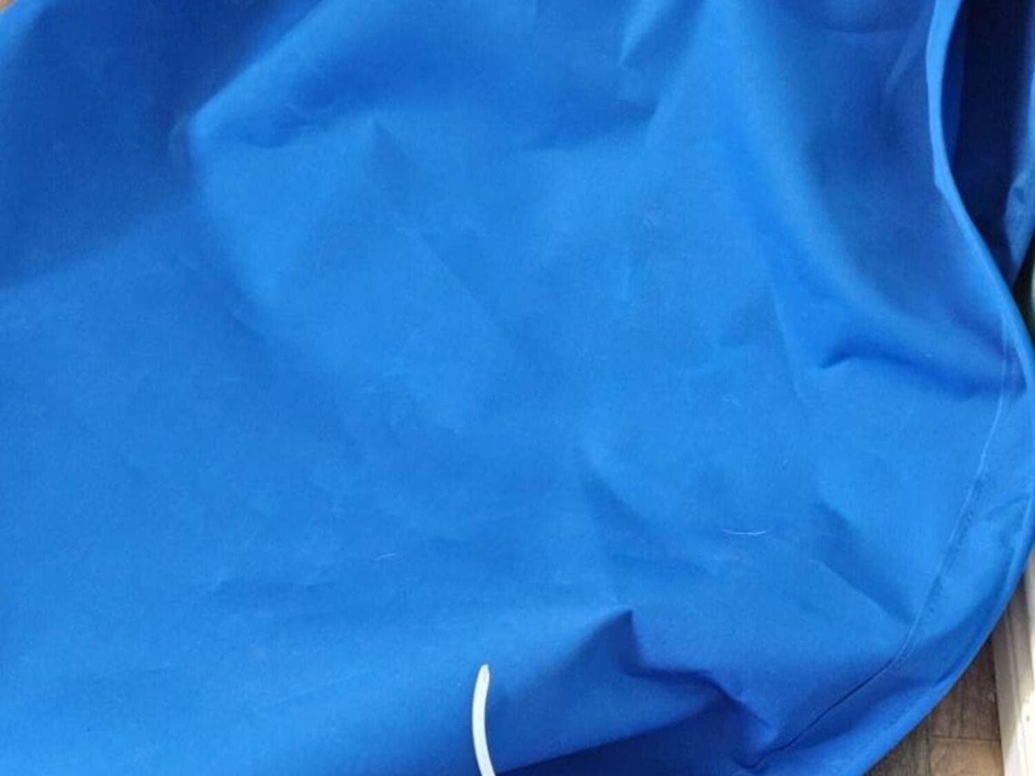 Roll of marine-grade blue Sunbrella awning canvas on the cutting table at the Texas Made Shade Seguin shop