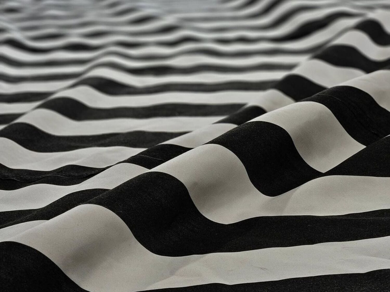 Black and white striped Sunbrella awning fabric laid out for patterning on the shop floor
