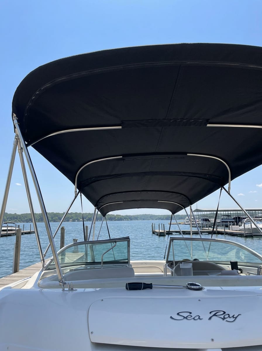 Custom black Sunbrella marine canvas double-tier bimini top by Texas Made Shade installed on a Sea Ray boat docked at a Texas marina