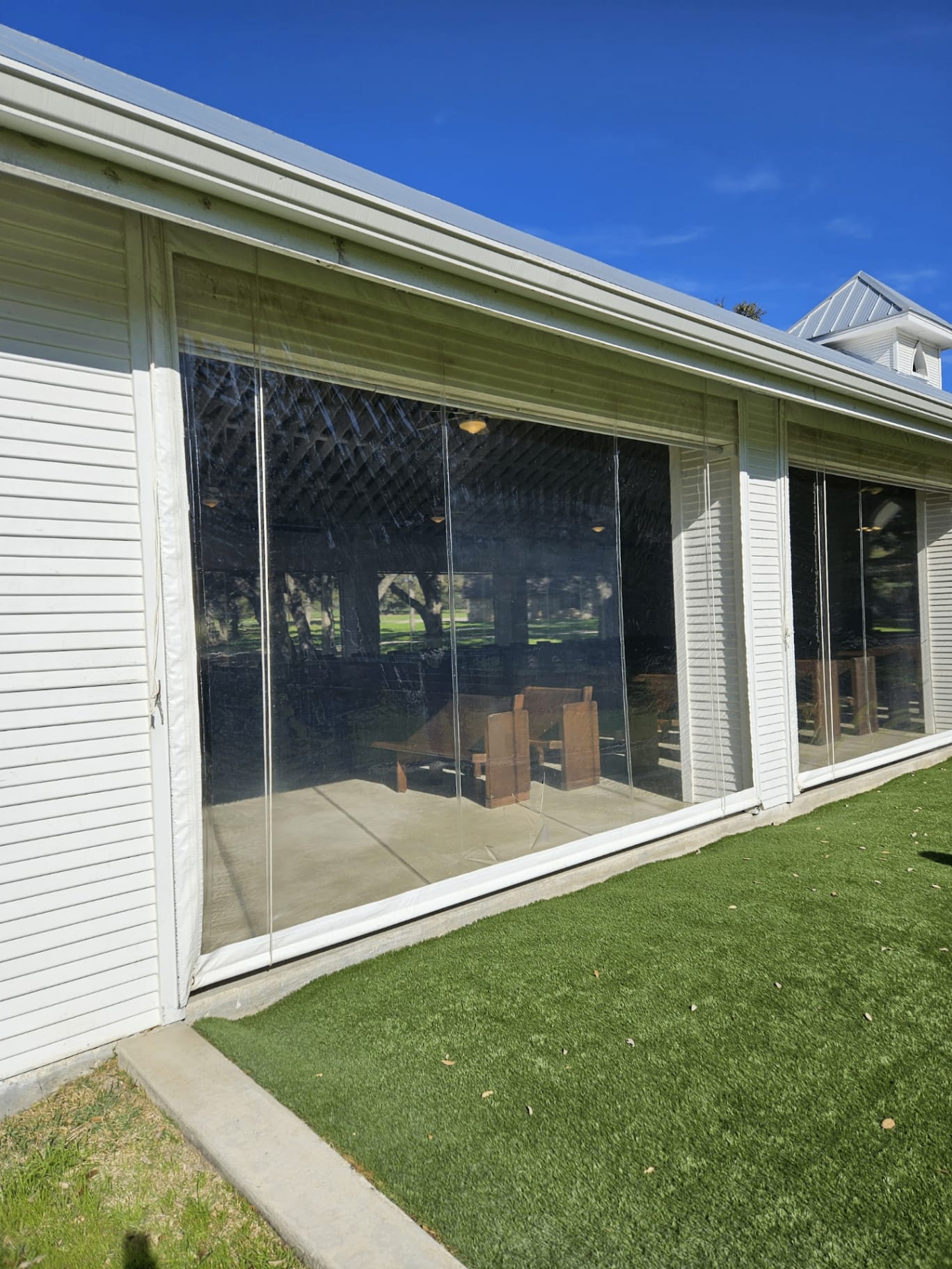Clear vinyl drop curtains enclosing a pavilion