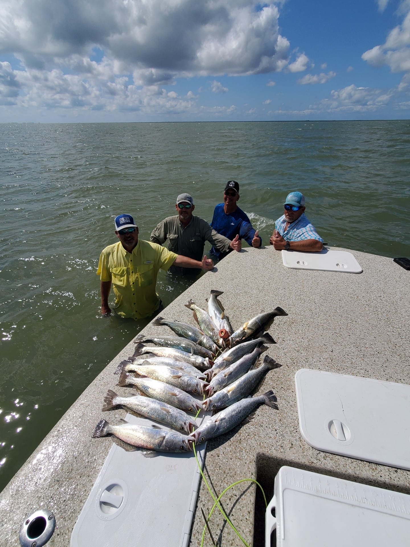 Limit of speckled trout laid out on a bay boat deck after a Texas coast fishing trip