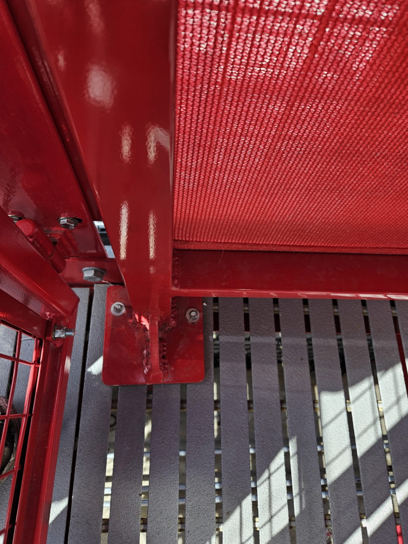 Welded powder-coated bracket detail — covered-parking post hardware