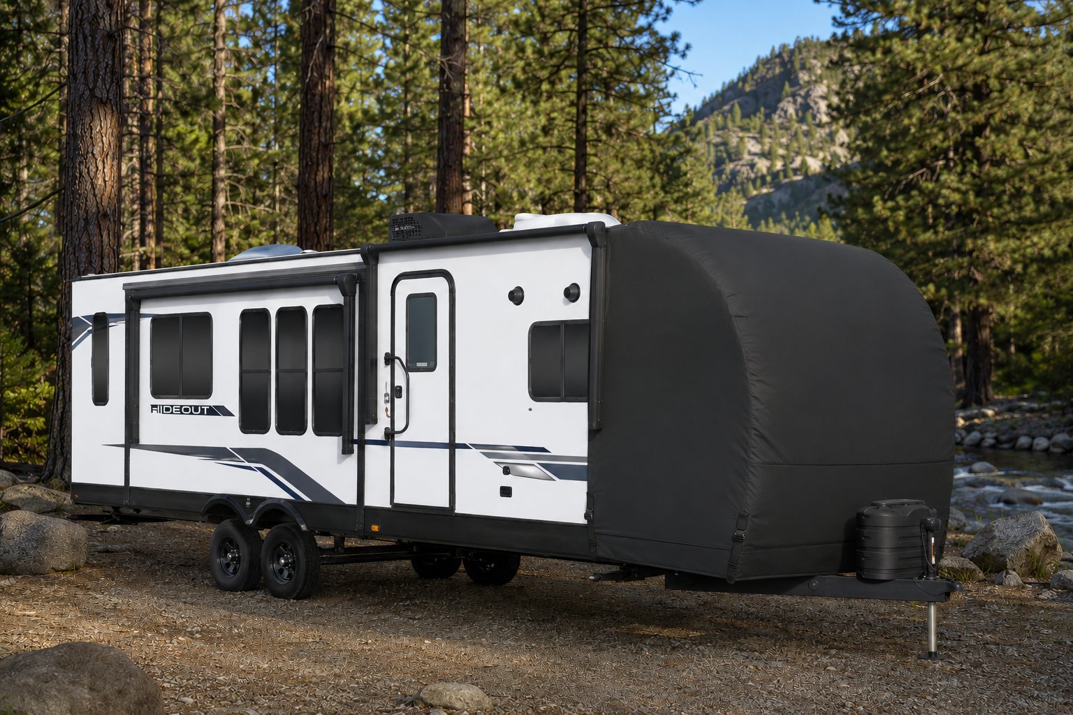 Custom-patterned protective front-cap tarp on a Hideout travel trailer parked at a Texas campsite — Texas Made Shade