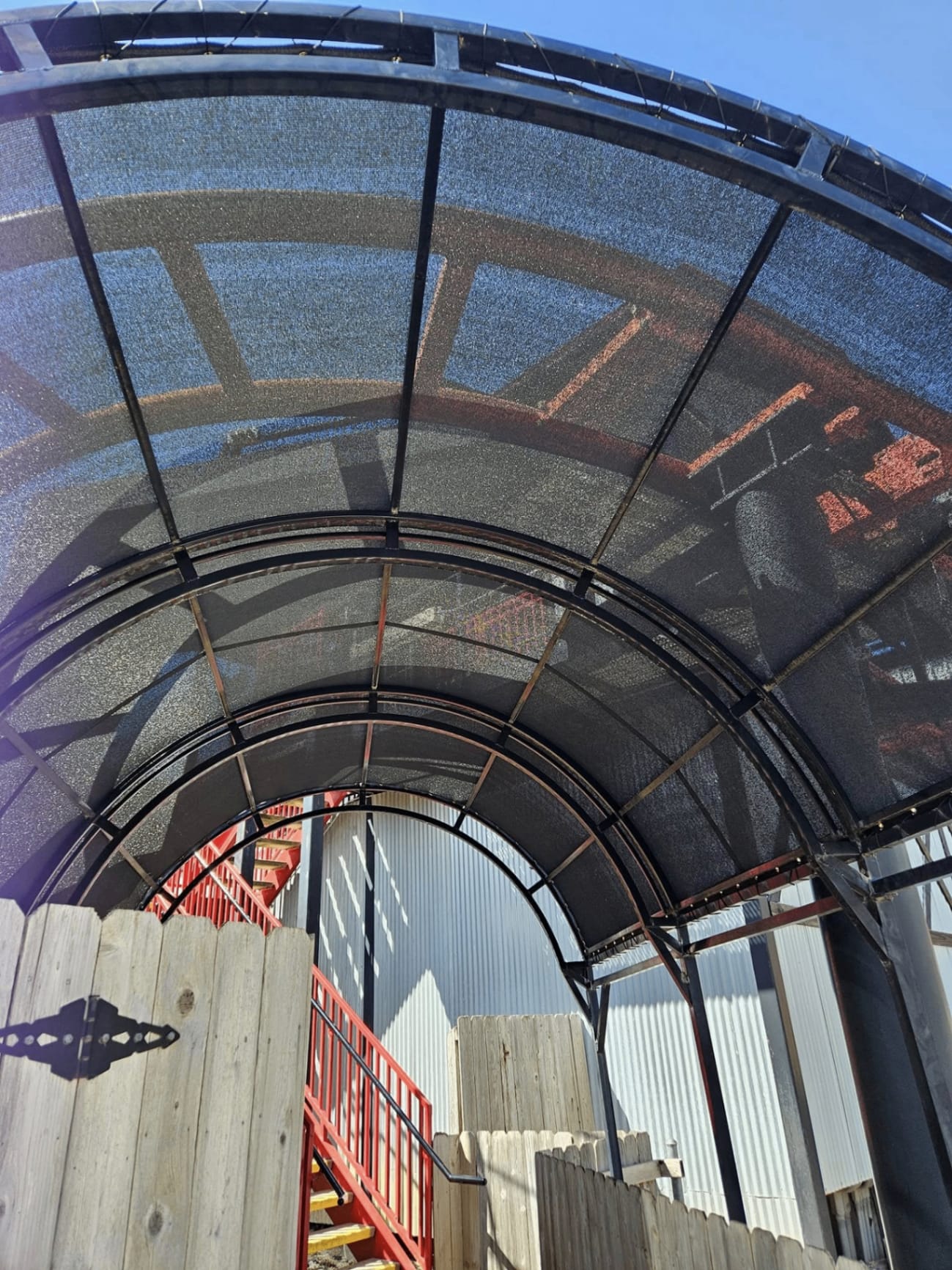 Black tensioned shade sail installed at a Texas property