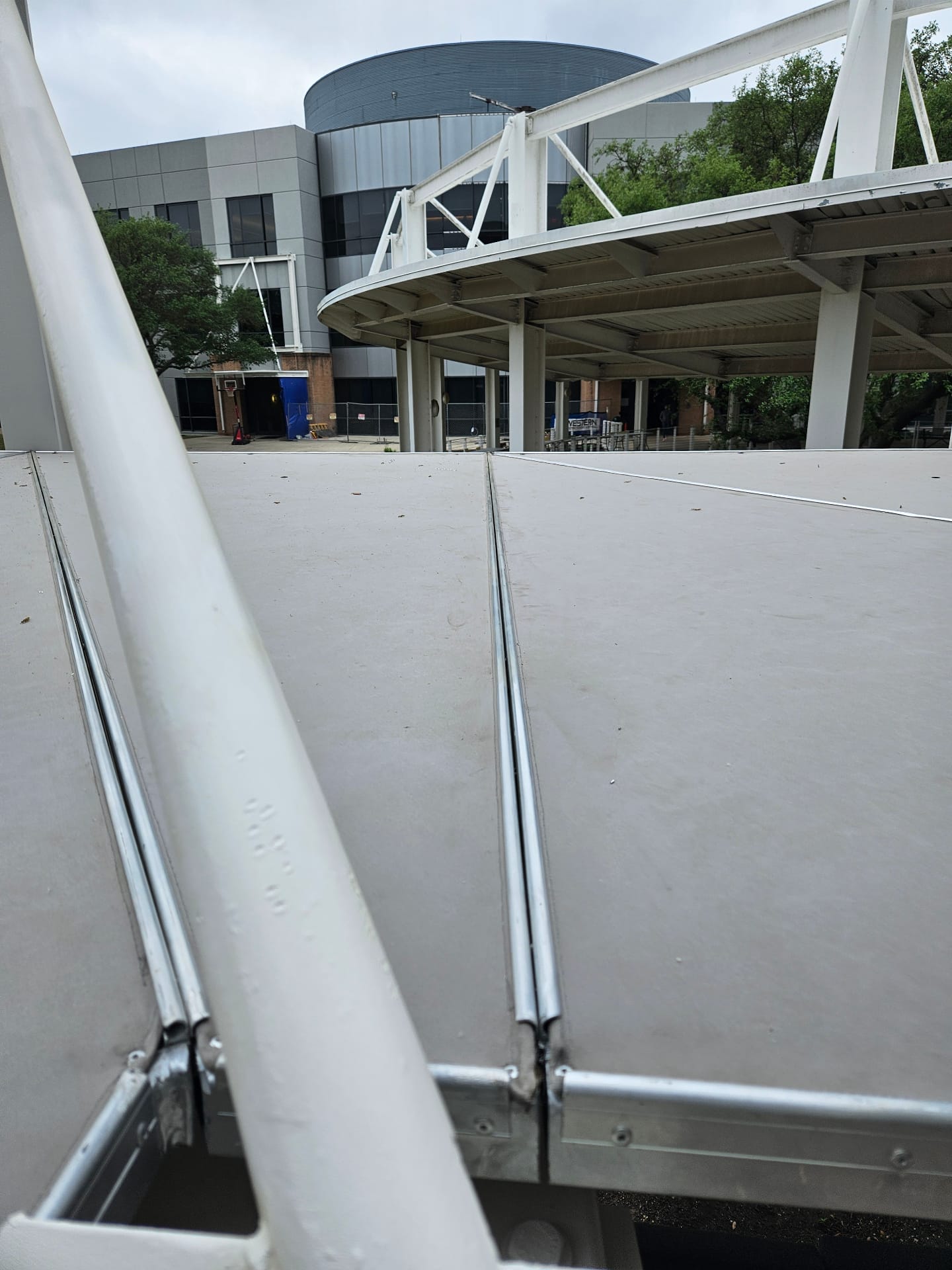 Large welded aluminum commercial canopy frame and canvas roof installed at a corporate campus in Austin, Texas — fabricated and installed by Texas Made Shade